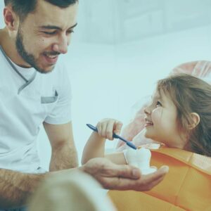 Monitor your child's oral health with a parent checking a child's teeth